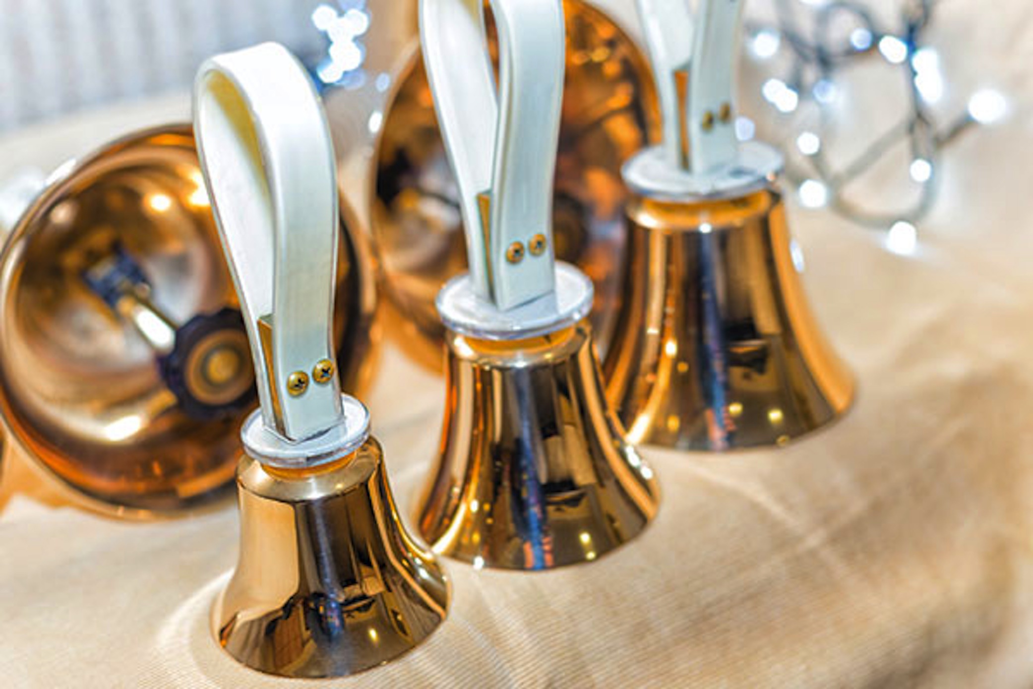 Set of gold hand bells on table during concert