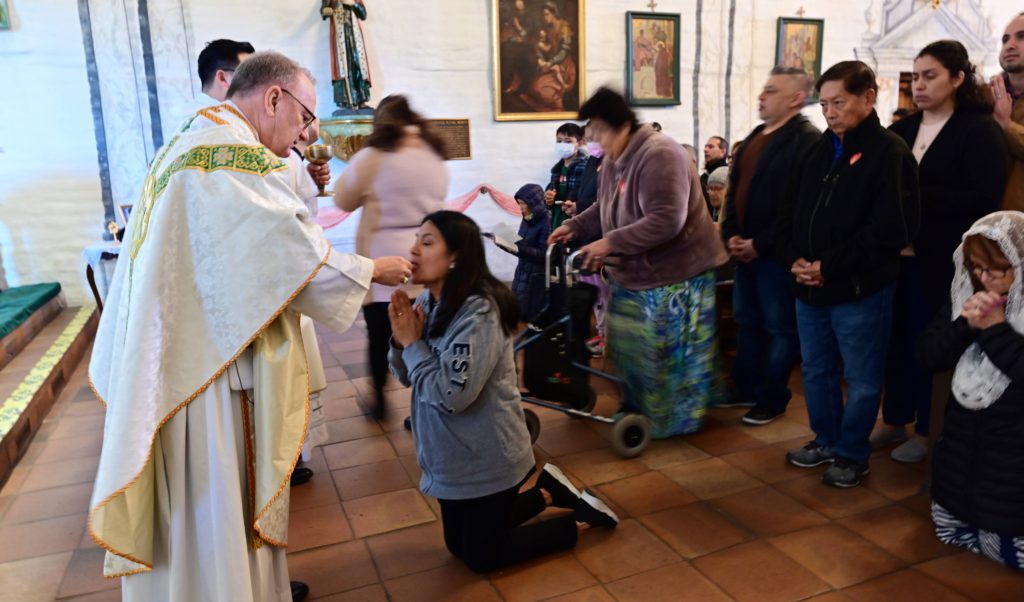 Bishop Barber giving communion